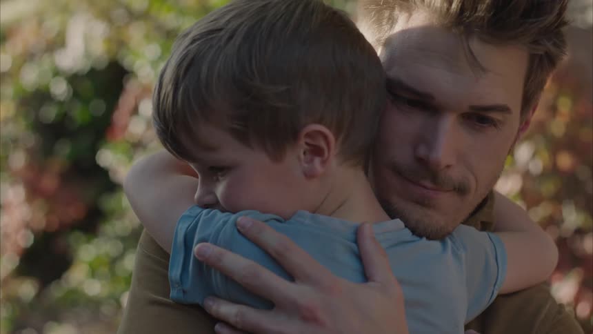 Son giving a hug to his father