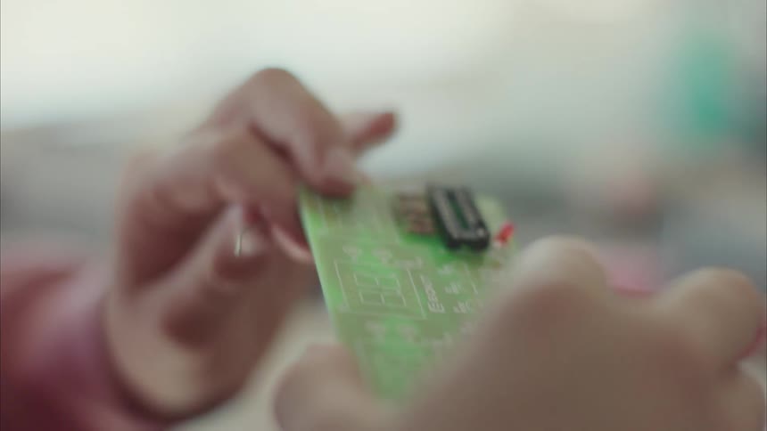 Closeup of a girls hands holding a hardware board
