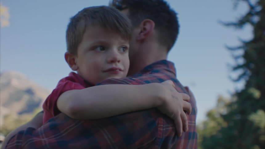Father holding his son in an openair location