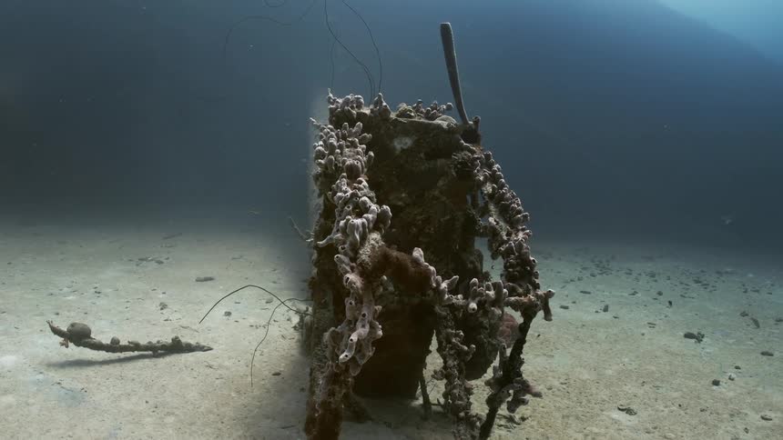 Rusted remains of a shipwreck underwater