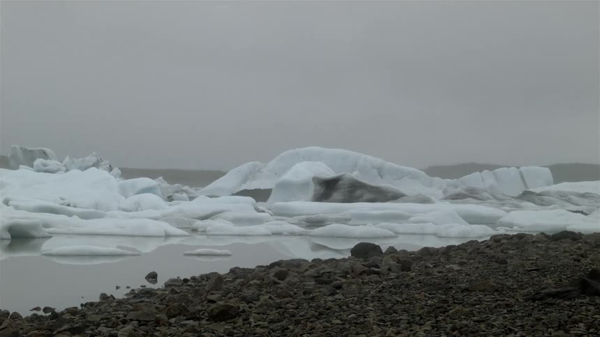 Icebergs fill the water near the shore