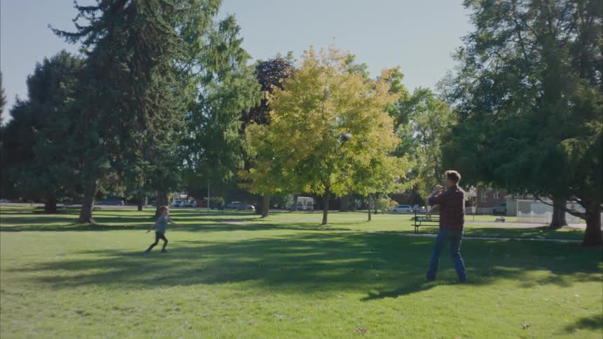 A father and a son playing american football