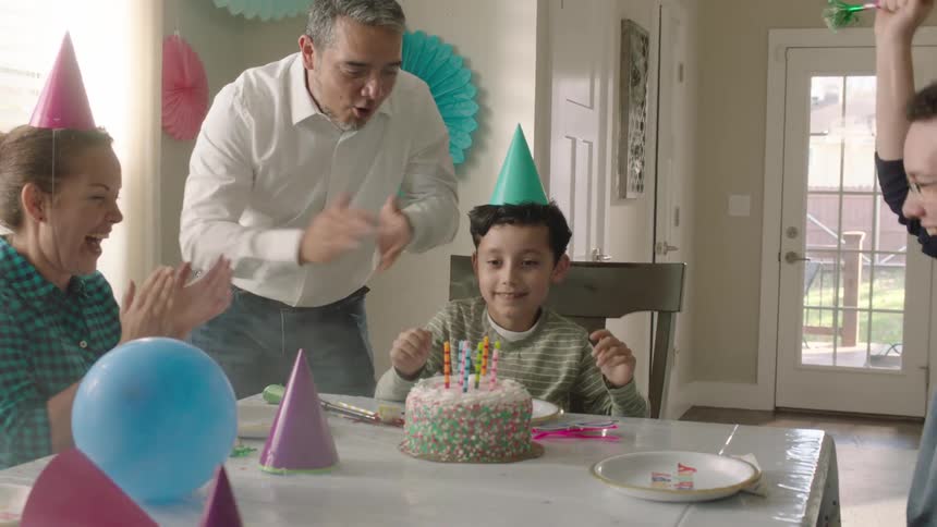 A family celebrating their youngest sons birthday