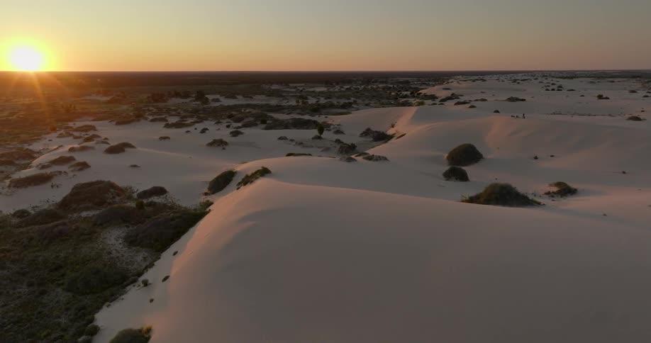 Panorama of the sun rising in the midst of a desert