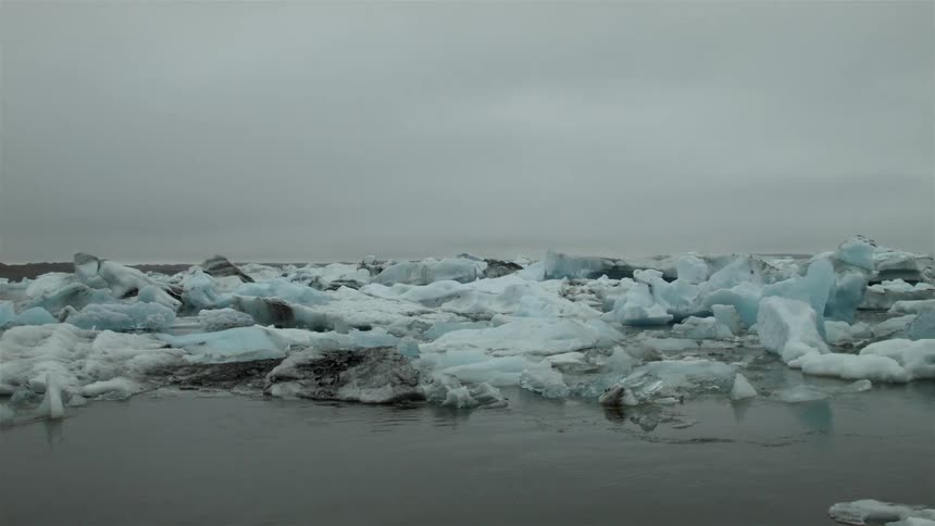 The water has many large icebergs floating around