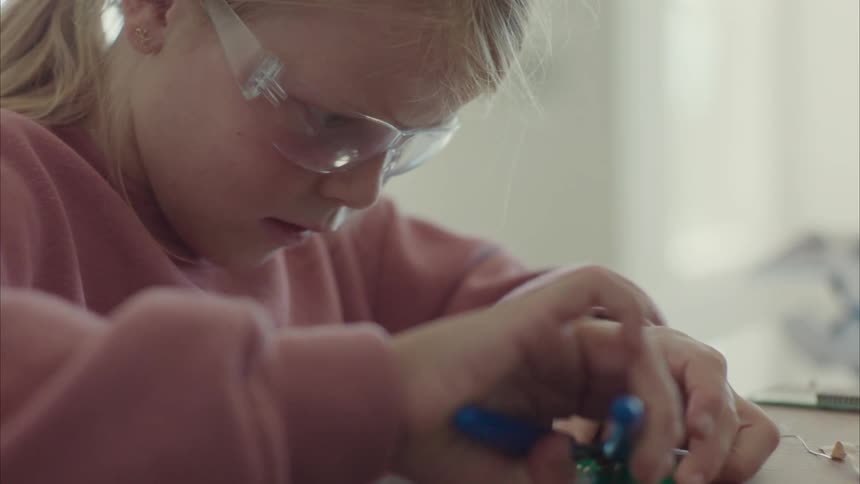 Girl soldering a small software board