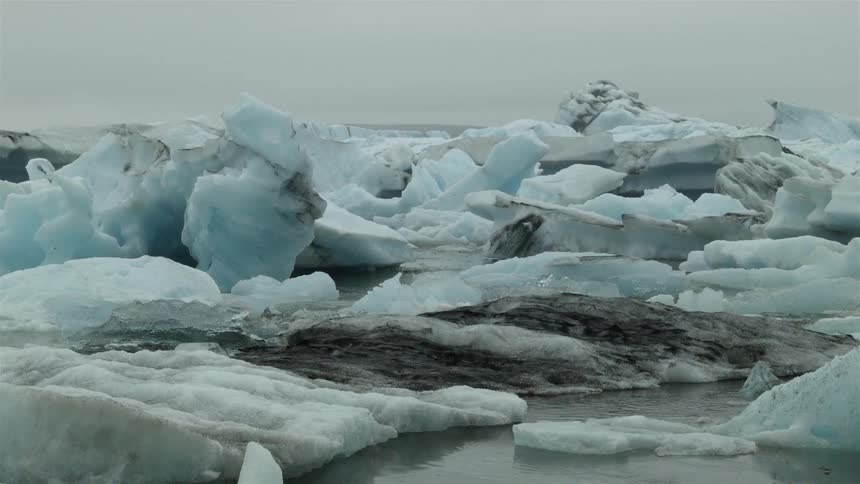 Ice formations sticking out of cold waters