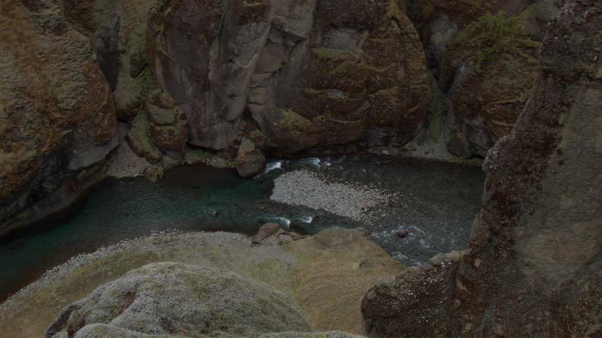 Aerial view of a river flowing through a cavernous area