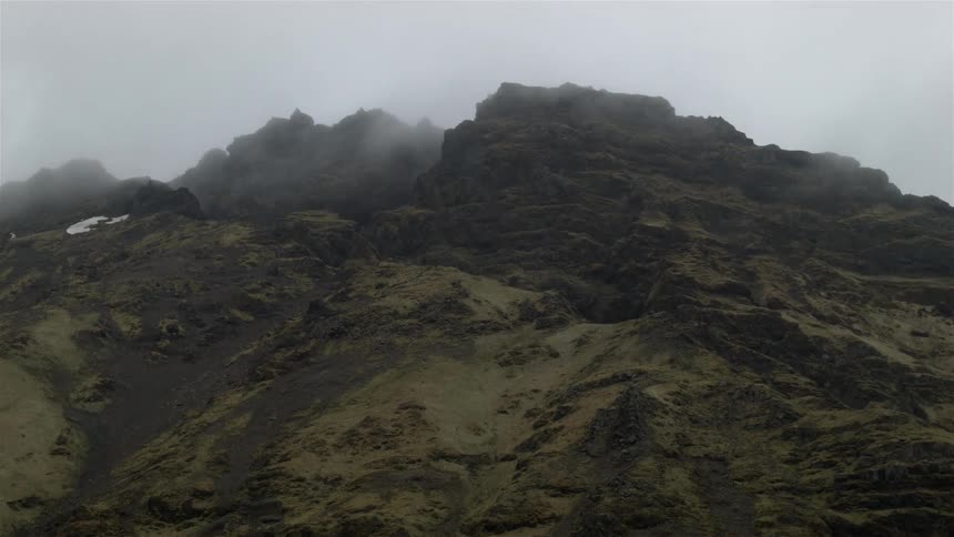 Clouds touch the top of this mountain