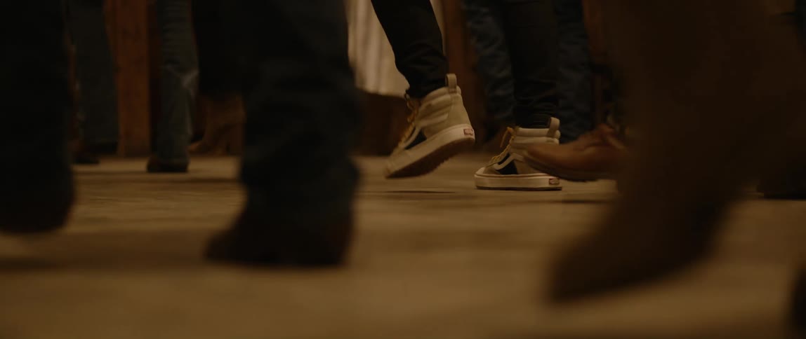 Legs of people dancing in unison at night