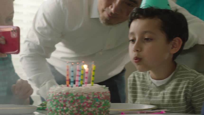 A family celebrating their sons birthday