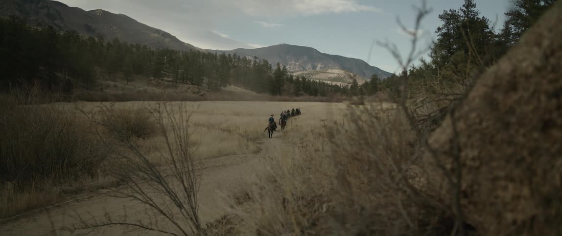 People riding horses in a landscape