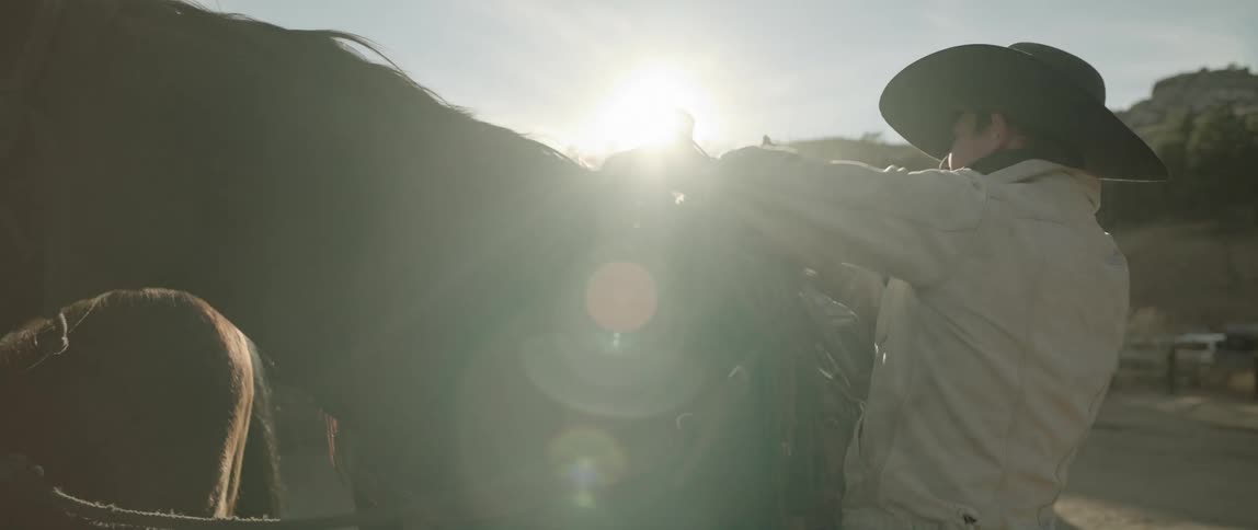 A man preparing his horse