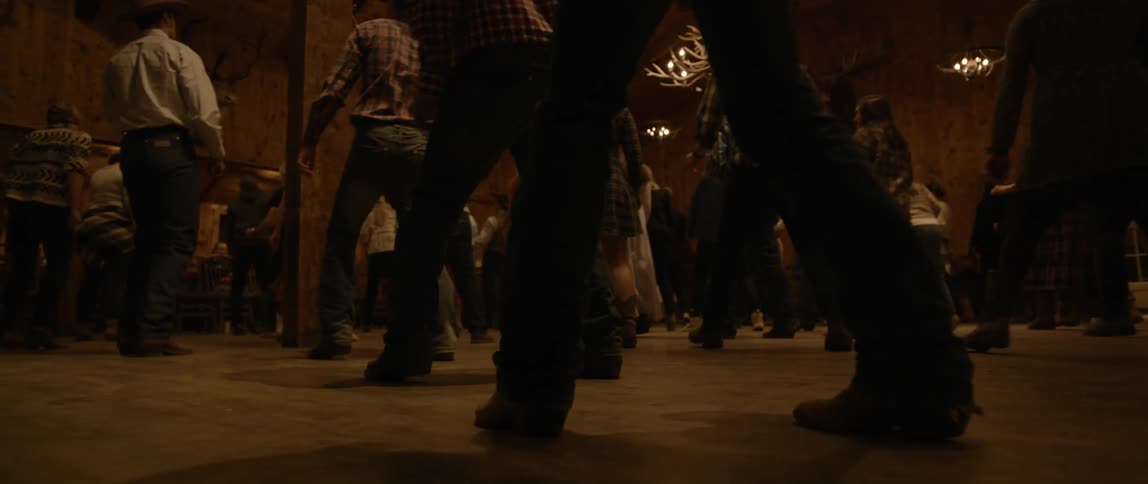 People in a hall dancing the same choreography