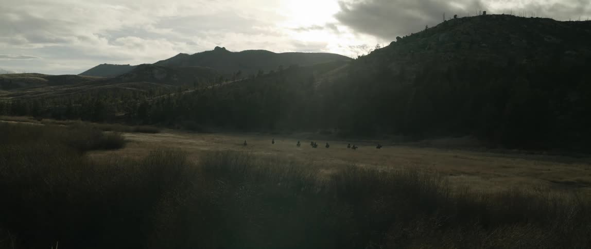 Landscape of a field with mountains around