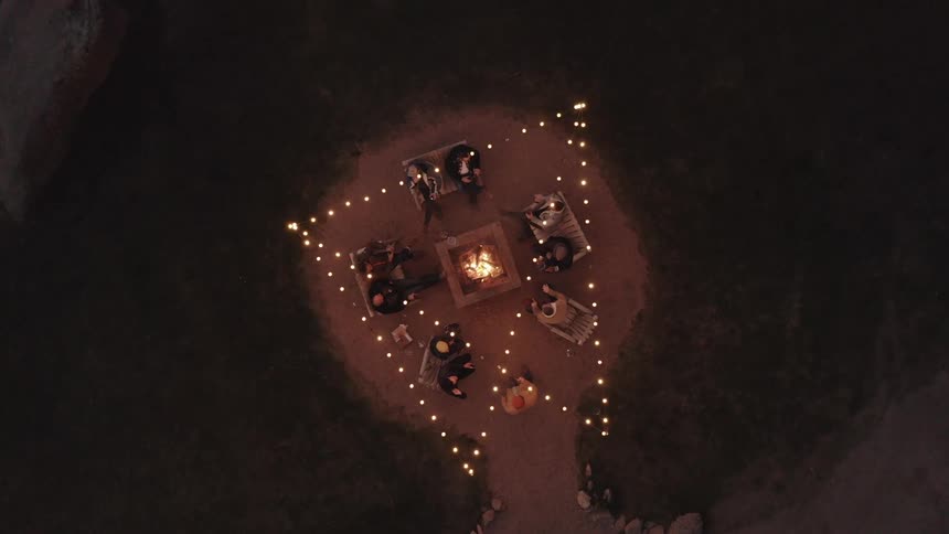 Aerial view of people sitting around a campfire