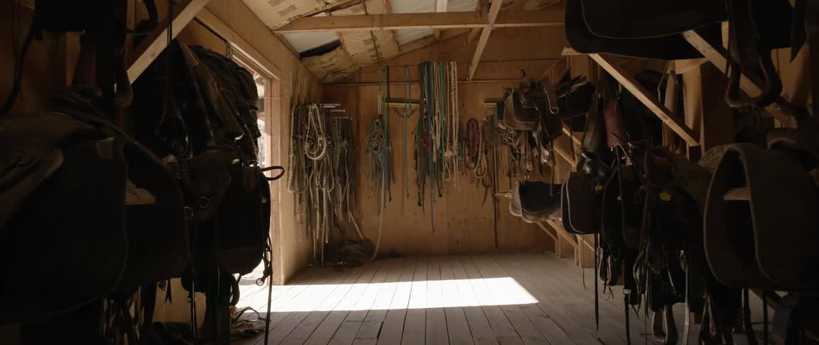 A stable with several horse saddles