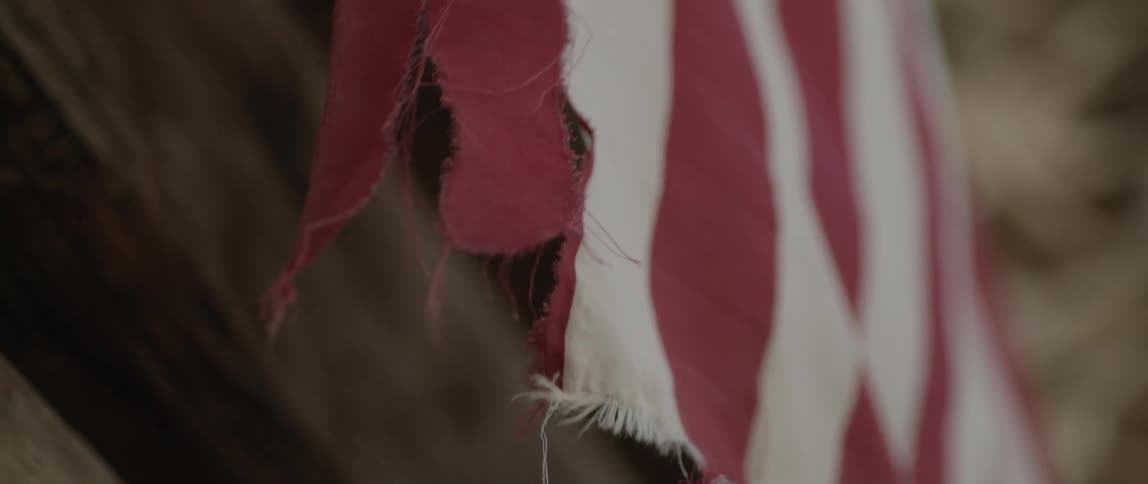 A torn american flag waving in the wind