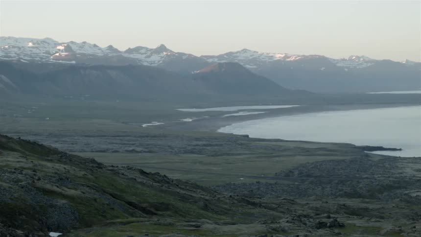 A mountain range has a lake nearby