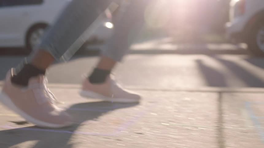 Girl playing hopscotch in the street at morning