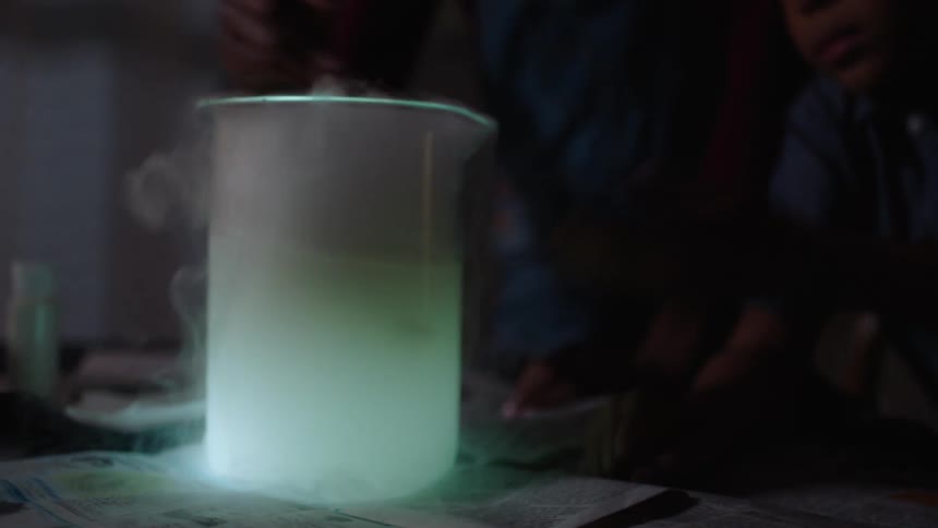 Two kids doing an experiment at home