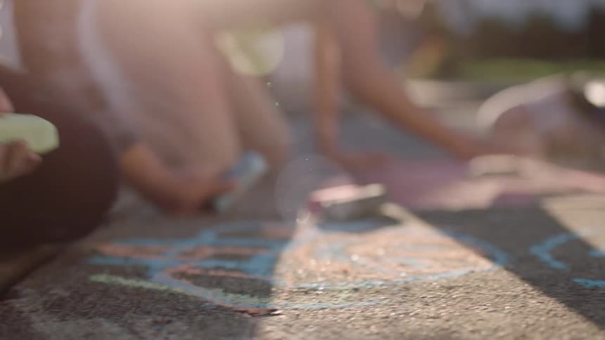 A clip of kids playing and drawing on the floor