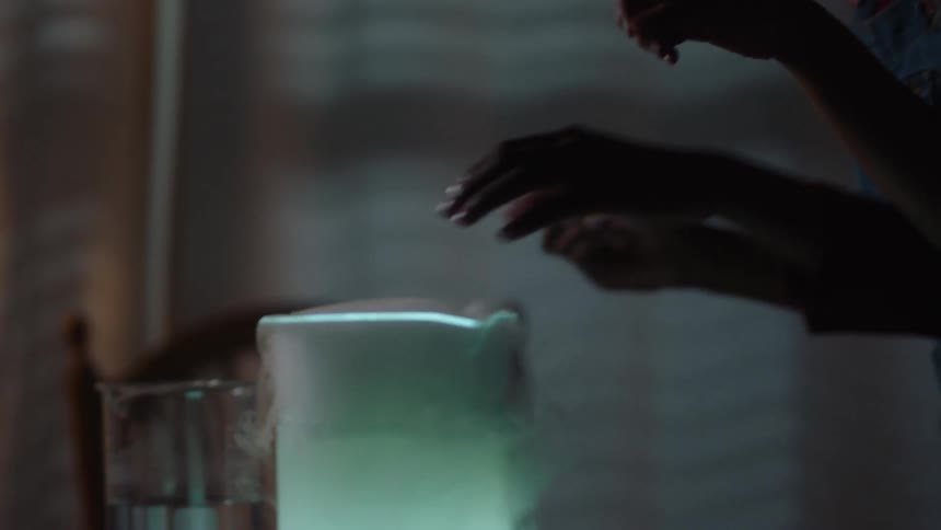 Two children touch the steam coming off the pitcher