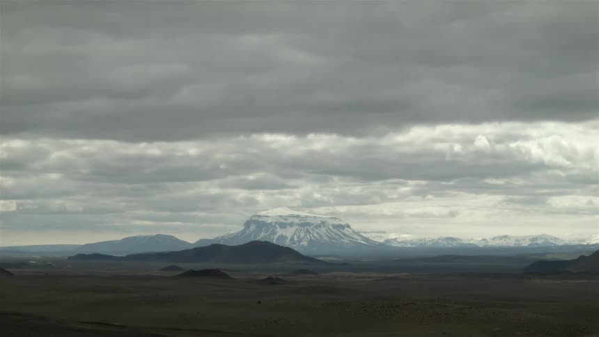 Wide view of open plains and mountains on a very cloudy day