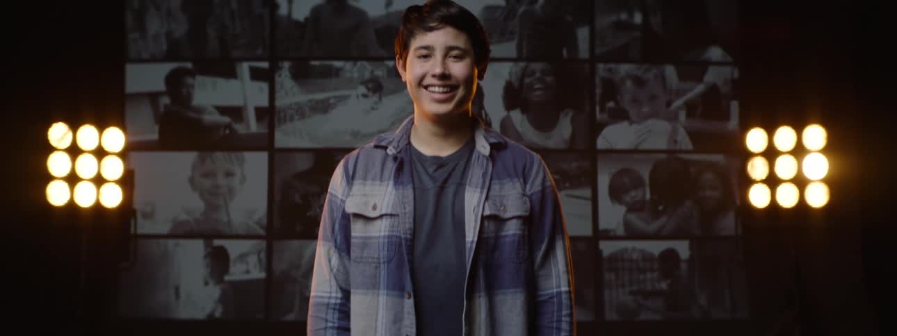 Portrait of a boy breaking into a smile in an indoor room