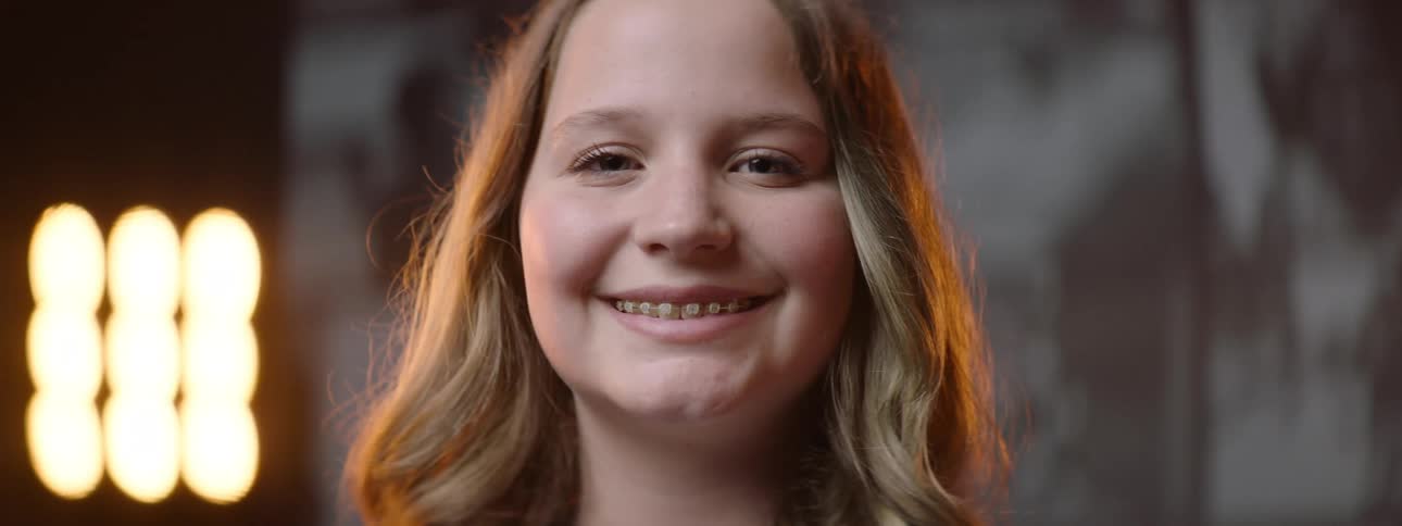 Closeup of a blonde girls face smiling