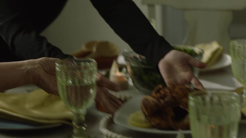 Mother and daughter serving dishes