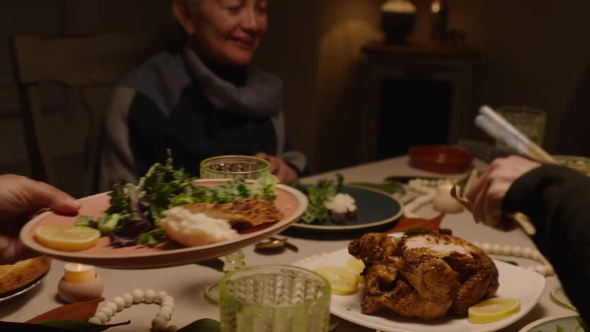 Family sharing turkey on thanksgiving dinner