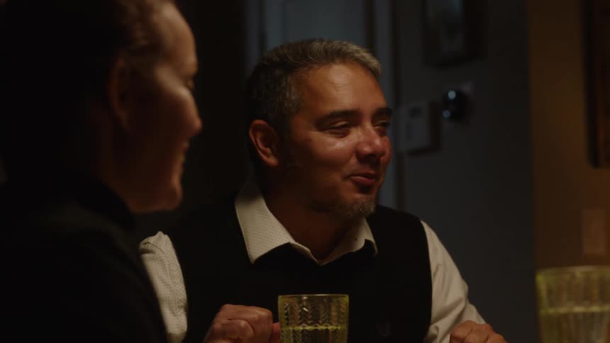 Portrait of people sitting at a dining table and talking