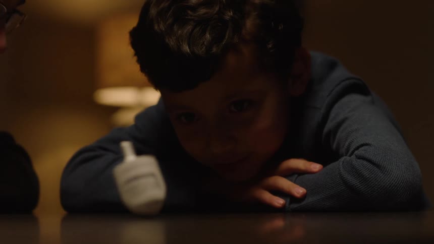 A boy watching a rolling toy