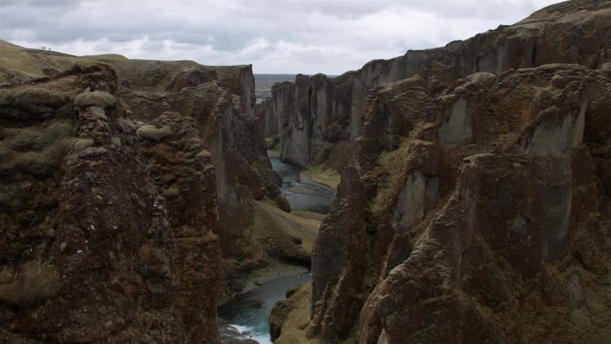 A river flows through large rock formations