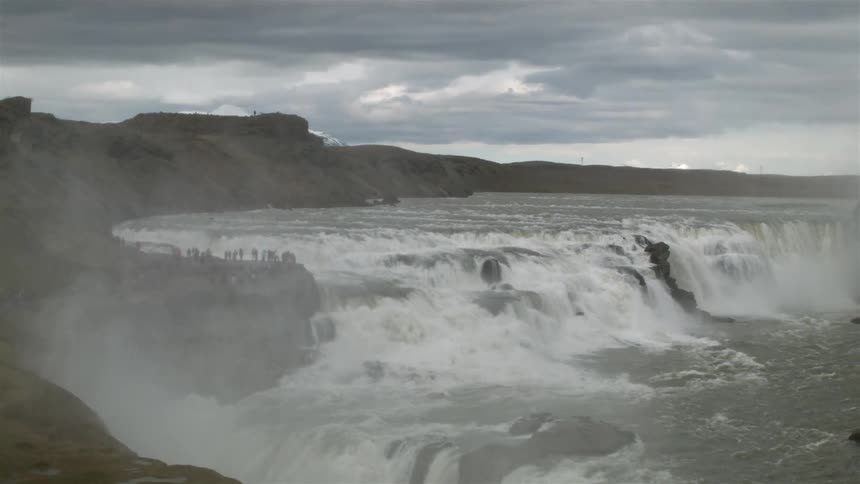 The rapids below are giving off a strong mist of water