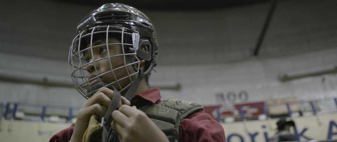 A man latches his helmet on