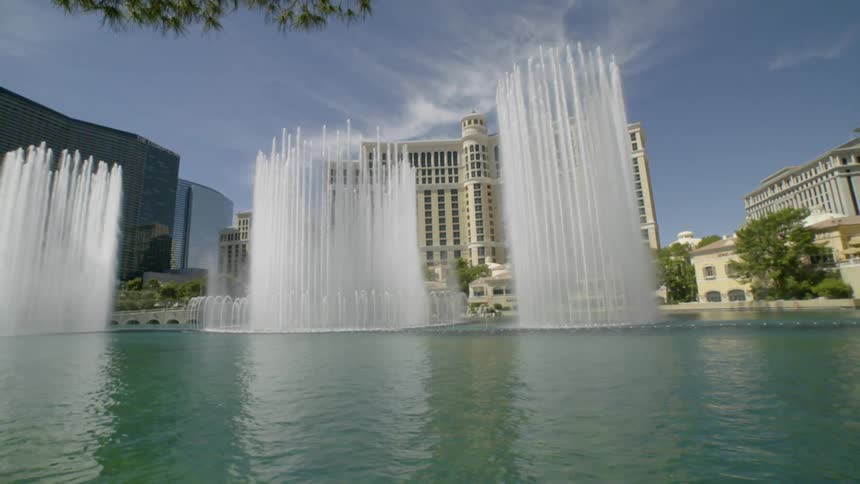 A water fountain sprays into the air in front of a casino ahead