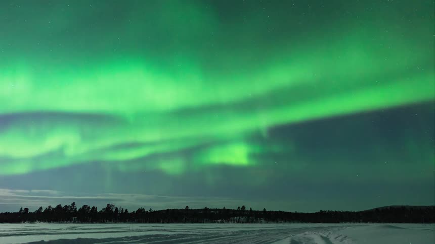 Time-lapse of green northern lights over a rural area