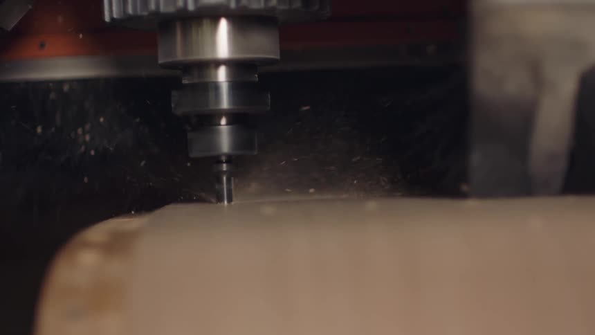 A hole machine rotating to make a hole in wood