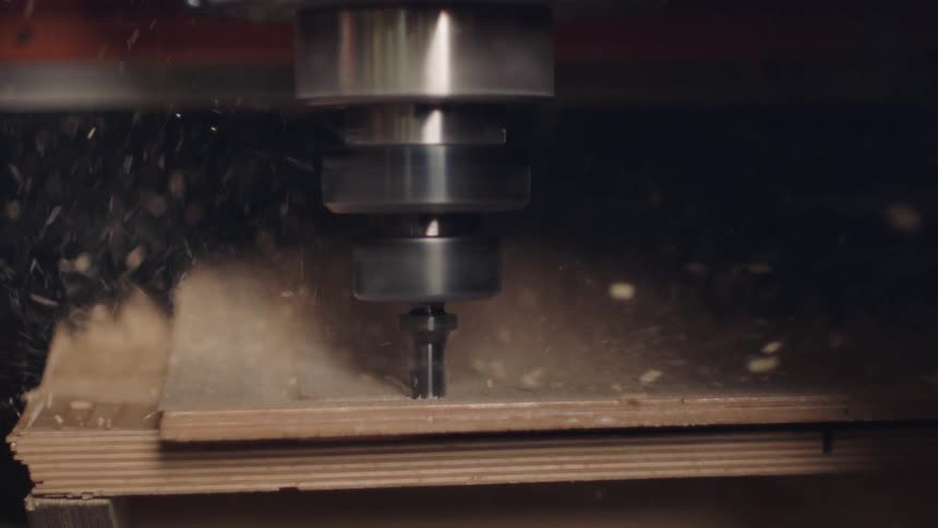 A workshop tool spinning on a wooden surface blowing off dust