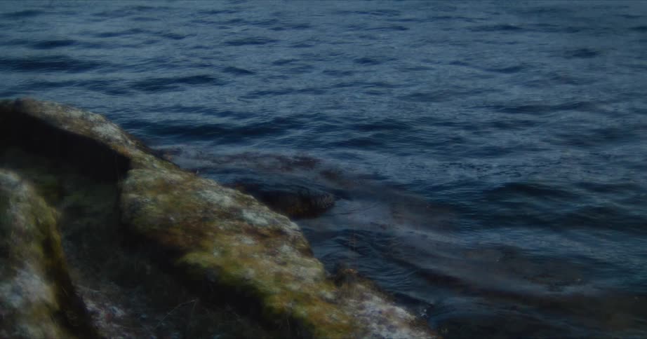 Closeup of the sea with gentle waves lapping against rocks