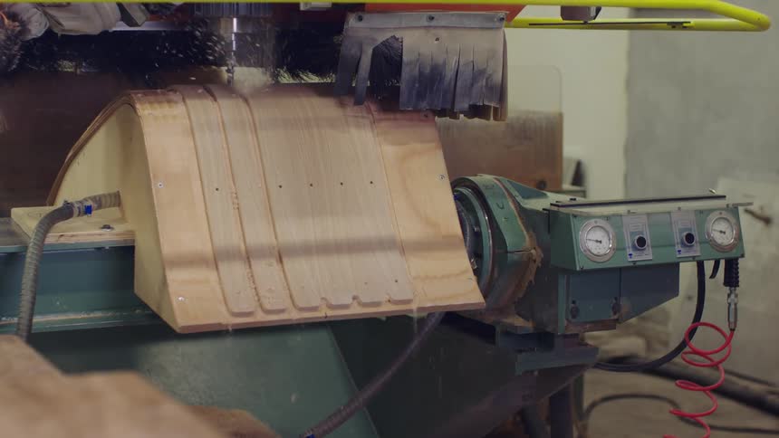 An industrial machine cutting wood