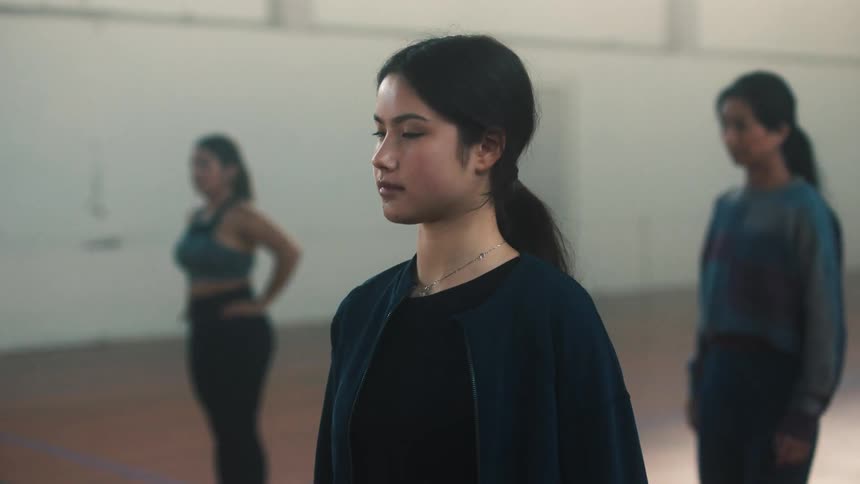 Three women are stretching their legs