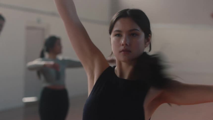 Dancers doing ballet spins on an indoor court