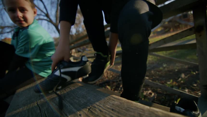 Boys putting on their boots to play football