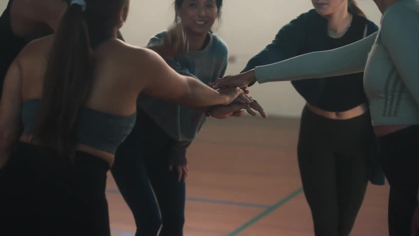 Friends in a circle celebrating as a team