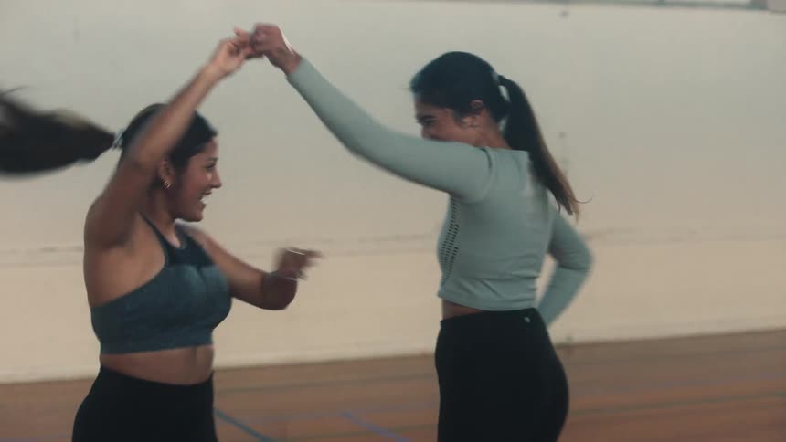 Group of friends dancing inside an indoor court environment