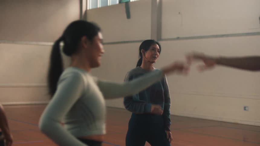 A group of dancers doing warmup exercises