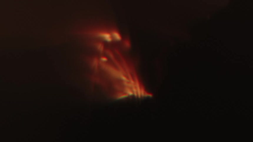Several orange lights running in a dark environment